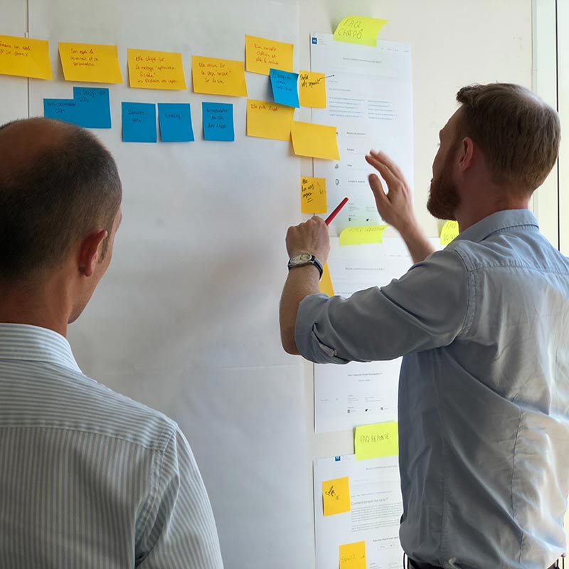 picture of two people discussing white board